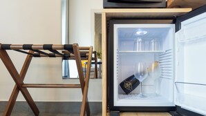A compact refrigerator with a wine glass and a bottle inside. - Centro Storico via Sassari Accommodation (Cagliari)