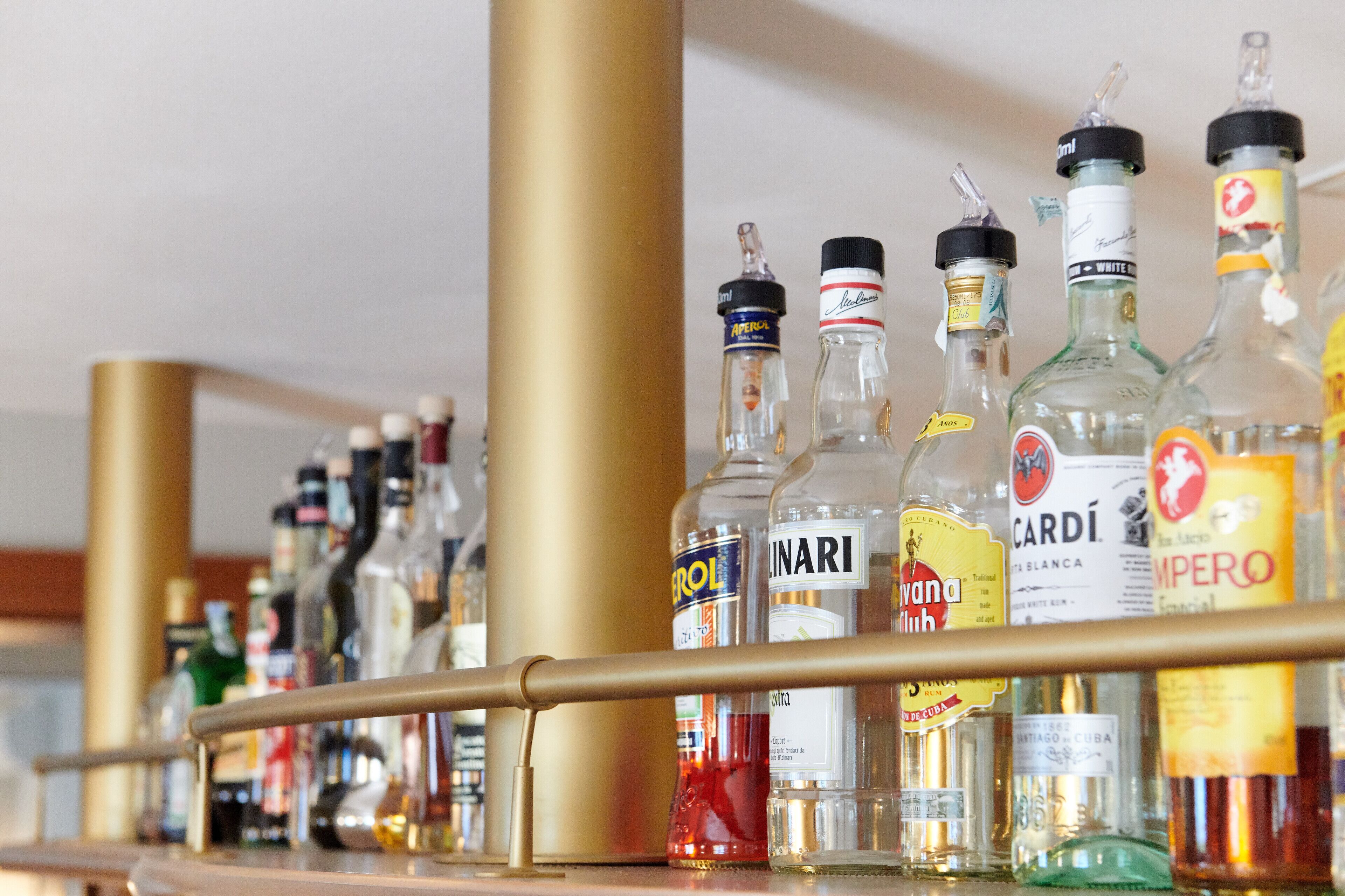 A bar with various liquor bottles, including brands like Cointreau and Jim Beam.