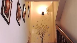 A staircase with a handrail and a wall with framed pictures. - Fu Xing Homestay (Magong)