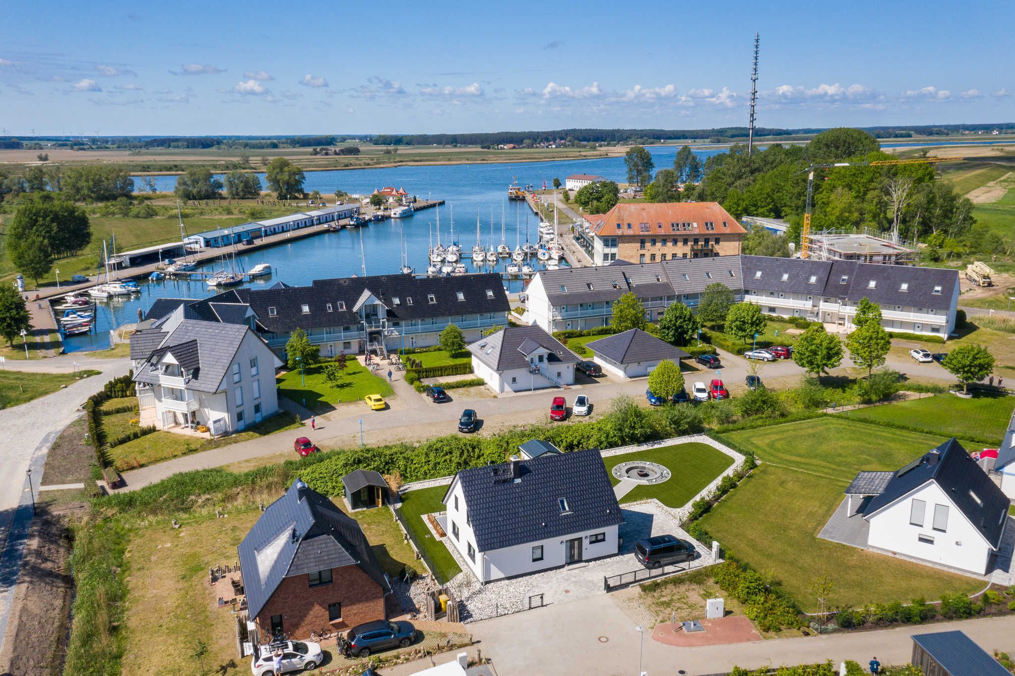 A residential area with houses, a marina, and a body of water.