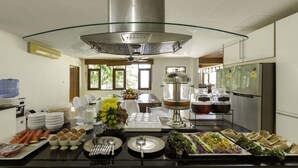A modern kitchen with a central island, a water dispenser, and a refrigerator.