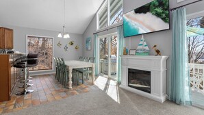 Una cocina amplia con comedor, chimenea y un ventanal con vistas panorámicas.