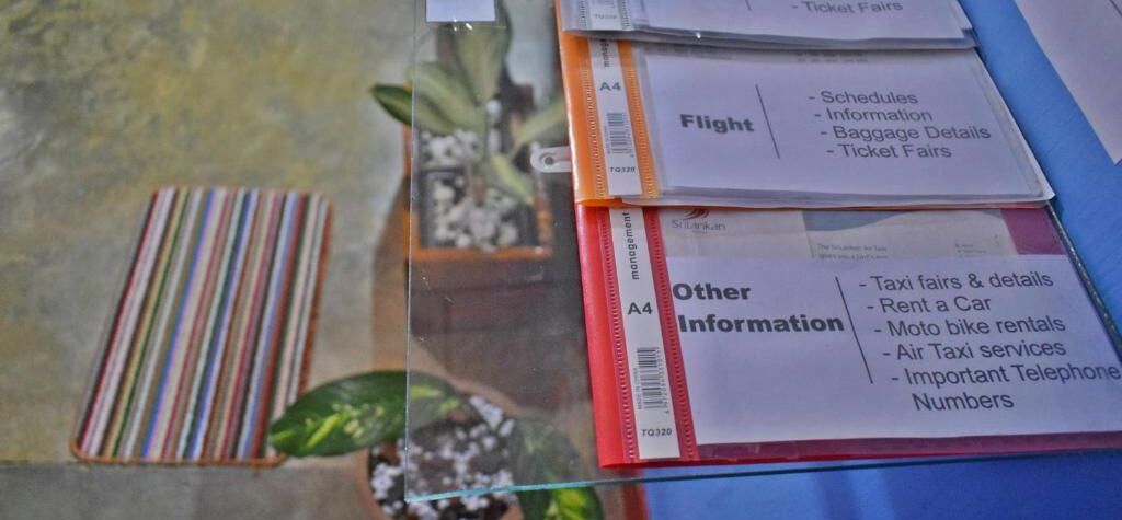 A glass display case with brochures for flight and other travel information.