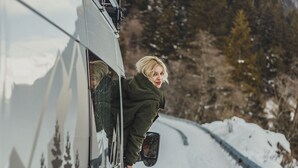 A vehicle parked on a snowy road with a person leaning out of the window. - Self-built campervan (Kutaisi)