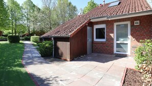 A residential building with a sloped roof, a front door, and a mailbox. - Vacationer village 43c, Germany (Ostseebad Boltenhagen)