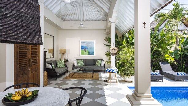 A covered patio with a checkered floor, a pool, and lush tropical plants. - Villa Alliv (Seminyak)
