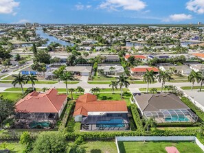A residential area with houses, a swimming pool, and a marina.