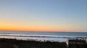 A beach scene with waves, a wooden structure, and a fence. - OIBs #1 OCEANFRONT CONDO CLOSEST 2BEACH LINENS & TOWELS INCLUDED BOOK NOW (Ocean Isle Beach)