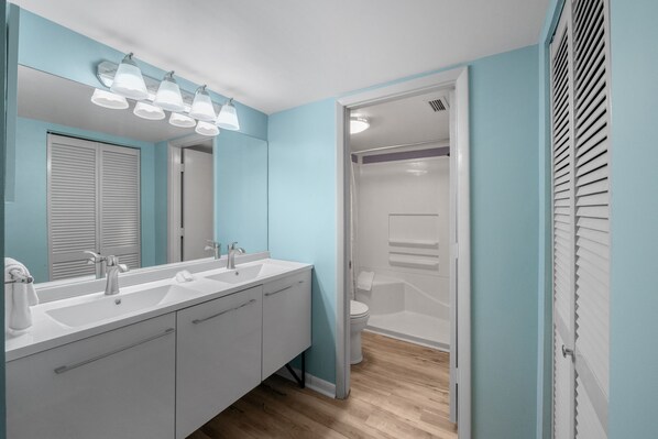 A bathroom with two sinks, a mirror, and a shower. - Newly Renovated Oceanfront Unit In Quiet Building + Free Attraction Tickets! (Myrtle Beach)