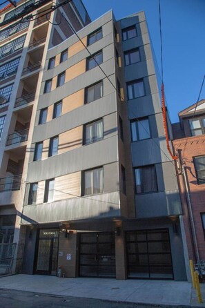 A multi-story building with a modern architectural style, featuring a ground-level commercial space with a storefront labeled "KESTREL." - Billy Penn Studio at The Kestrel (Philadelphia)
