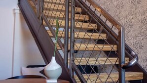 A staircase with a metal railing and wooden steps. - Mayor`s Study Loft at The Kestrel (Philadelphia)