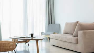 Signature Suite, 1 King Bed | Living room | Flat-screen TV