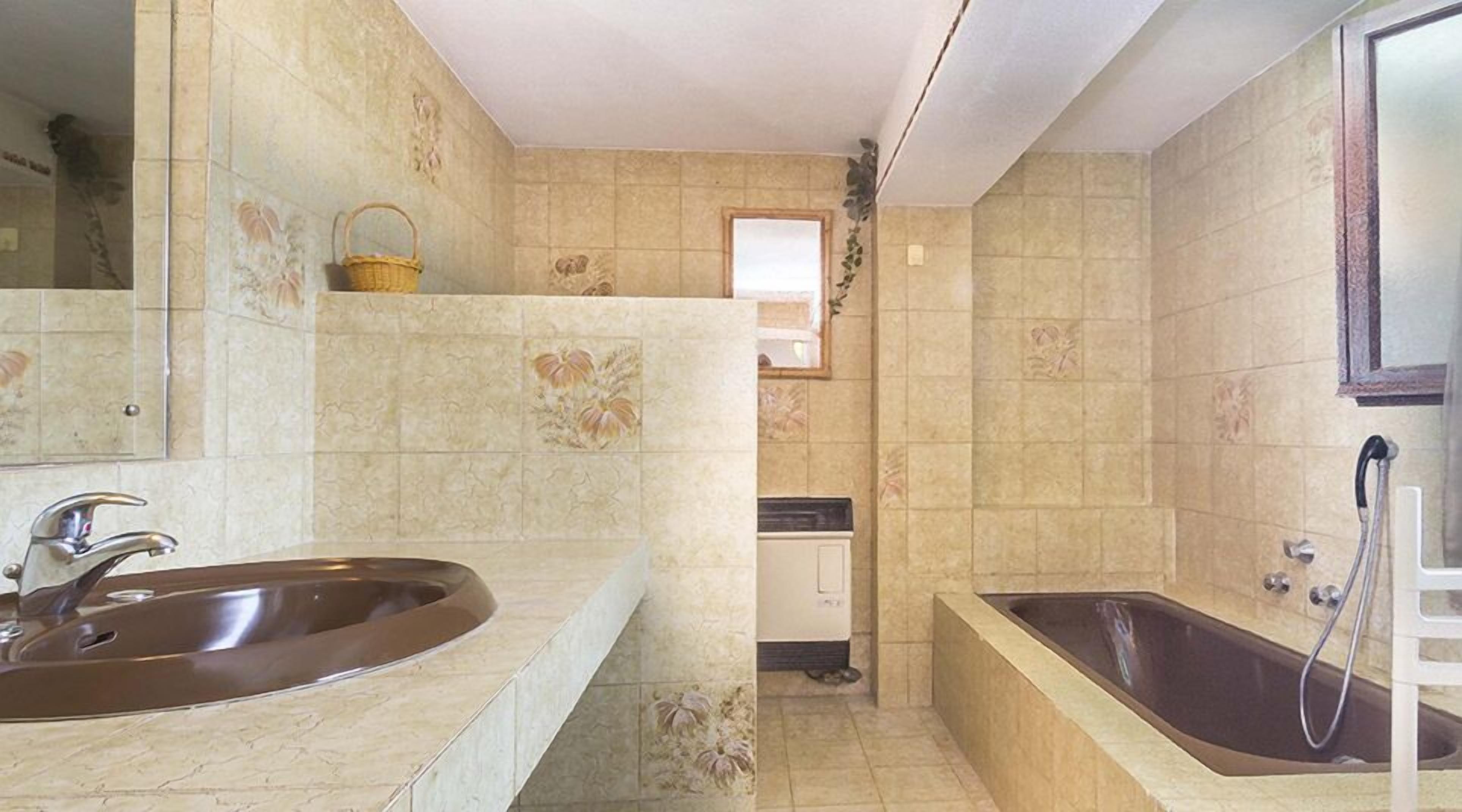 A bathroom with two sinks, a bathtub, and a shower.
