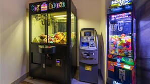 Two claw machines with plush toys inside, one labeled 'toy house' and the other 'Magician.' - Best Western Plus Dauphin (Dauphin)