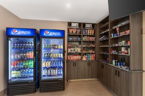 Two Pepsi vending machines and a variety of snacks and beverages in a store. - Best Western Plus Dauphin (Dauphin)