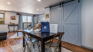 A dining area with a table, chairs, and a sliding barn-style door.