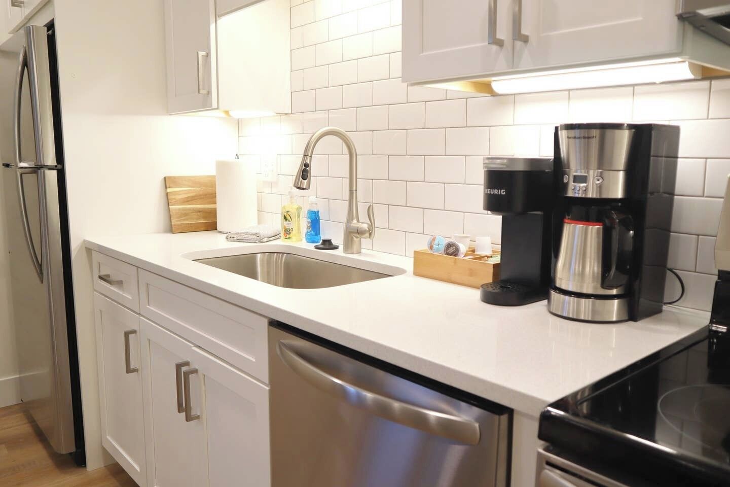 Fridge, microwave, coffee/tea maker, cookware/dishes/utensils