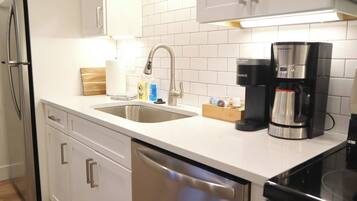 Fridge, microwave, coffee/tea maker, cookware/dishes/utensils