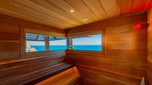 Puisesta laudelavasta ja ikkunasta koostuva sauna, josta avautuu näkymä merelle.