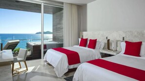 A modern hotel room with two beds, a balcony with a view of the sea, and a dining area. - Luxury Holiday Penthouse With Majestic Ocean Views, Cabo San Lucas Penthouse 1024 (San José del Cabo)