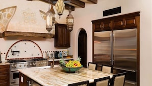A kitchen with a marble countertop, a stainless steel refrigerator, and a bowl of fruit. - Beautiful Holiday Villa in a Prime Location in Cabo San Lucas 1007 (Cabo San Lucas)