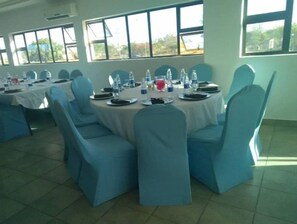 Guests can dine in comfort at a table set with fine china and crystal glassware.