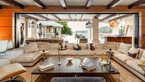 A spacious living area with a large L-shaped sofa set, a coffee table, and a view of the outdoors. - The Ultimate Holiday Villa in San José del Cabo With Private Pool and Close to the Beach, San Jose Del Cabo Villa 1008 (San José del Cabo)