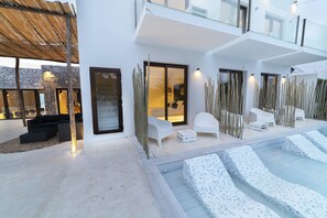 Una piscina al aire libre, tumbonas