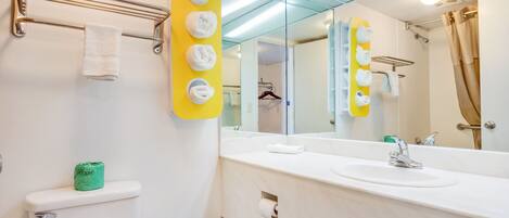 Un baño moderno con inodoro, lavabo y espejo.