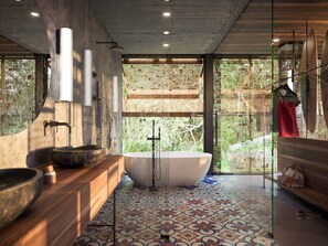 A modern bathroom with a freestanding bathtub, a wooden vanity, and a large window with a view of greenery.