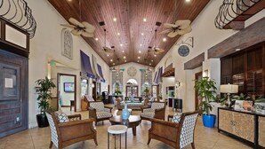 A spacious lobby with a high ceiling, wooden beams, and multiple seating areas. - Resort Home Sleeps 12 w/private Pool! (Kissimmee)