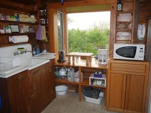 Fridge, microwave, coffee/tea maker, cookware/dishes/utensils