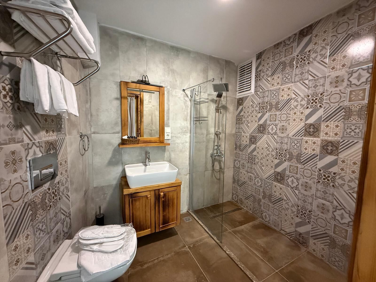 A bathroom with a shower, sink, and toilet.