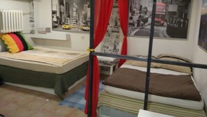 A bedroom with a bunk bed, a single bed, a radiator, and cityscape posters on the wall. - APARTAMENT W CENTRUM NOCLEGI PŁOCK (Plock)