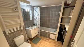 A bathroom with a toilet, sink, and shower. - 132 - Apartment 5 minutes from the ocean (MAUBUISSON)