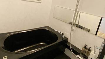 Combined shower/tub, free toiletries, hair dryer, slippers