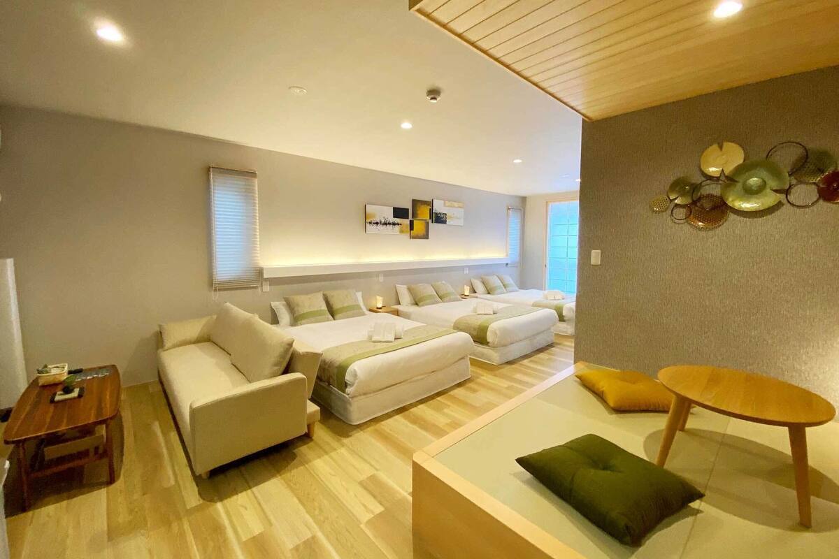 A modern living room with a sofa set, a coffee table, and a decorative wall piece.