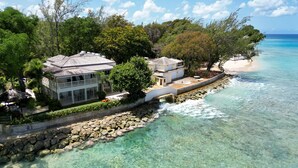 A coastal property with a large house, a beach, and clear turquoise waters. - Hemingway House by Blue Sky Luxury (Mullins)