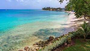 A clear view of a beach with a rocky shoreline and a clear blue sea. - Hemingway House by Blue Sky Luxury (Mullins)