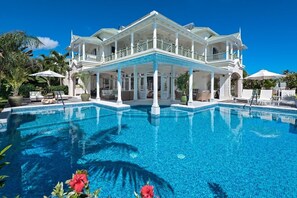 A large, two-story house with a pool in front. - Hectors House by Blue Sky Luxury (Silver Sands)