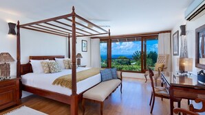 A spacious bedroom with a four-poster bed, a sitting area with a bench, and a view of the ocean. - Tom Tom by Blue Sky Luxury (Westmoreland)