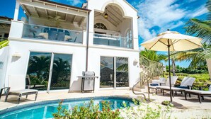 A two-story house with a swimming pool, outdoor seating, and a covered patio. - Royal Westmoreland - Sugar Cane Ridge by Blue Sky Luxury (Holetown)