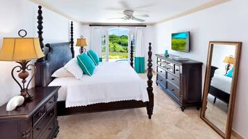 A bedroom with a four-poster bed, a dresser, a television, and a large mirror.