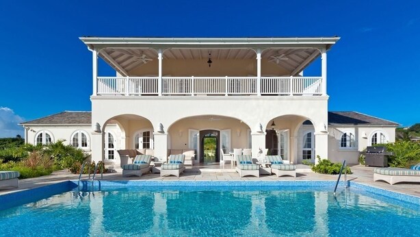 A two-story building with a swimming pool in front. - Royal Westmoreland - High Spirit by Blue Sky Luxury (Westmoreland)