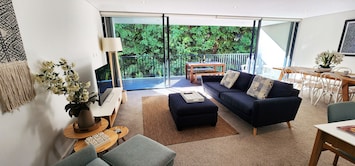 Living room with air con (cooling/heating) and large balcony