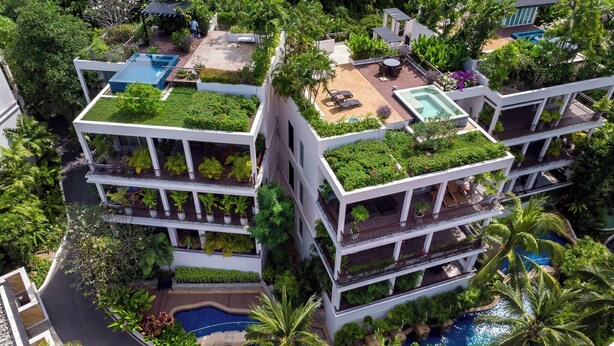 A multi-story hotel with rooftop gardens, balconies, and a swimming pool. - Kata gardens 2 bedroom near Kata beach 3B (Karon)