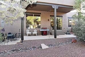 A covered patio area with outdoor seating, a barbecue grill, and a pergola. - Sedona Hacienda with Hot Tub, Firepit, Room for 9 and Private Yard. (Sedona)