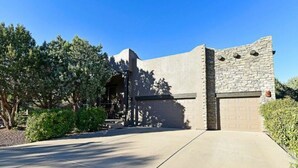 A modern building with a stone facade, a garage, and a paved driveway.