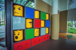 A wall with a colorful, grid-like design featuring various emoticons.