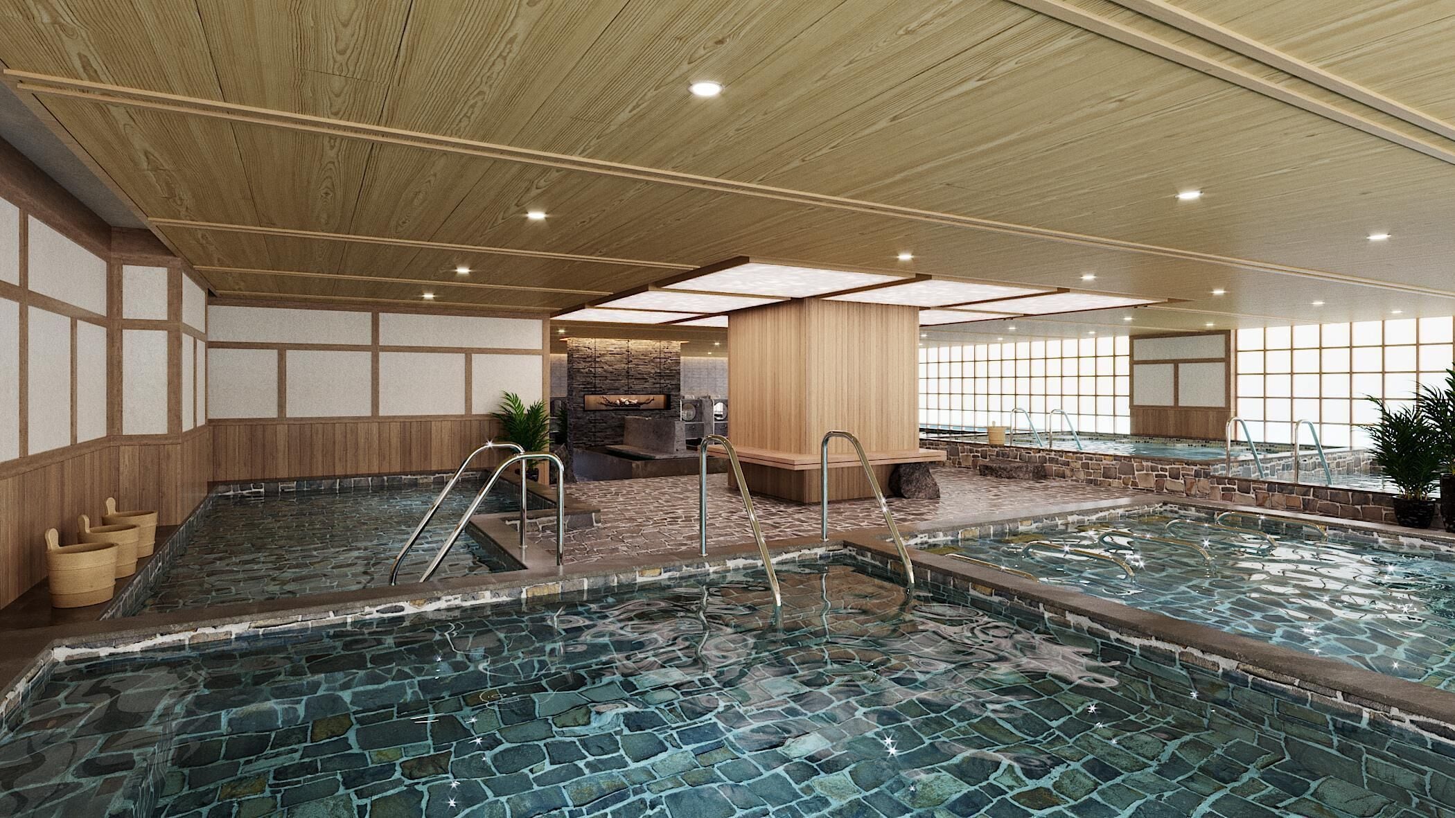 An indoor swimming pool with stone tiles, wooden walls, and a stone fireplace.